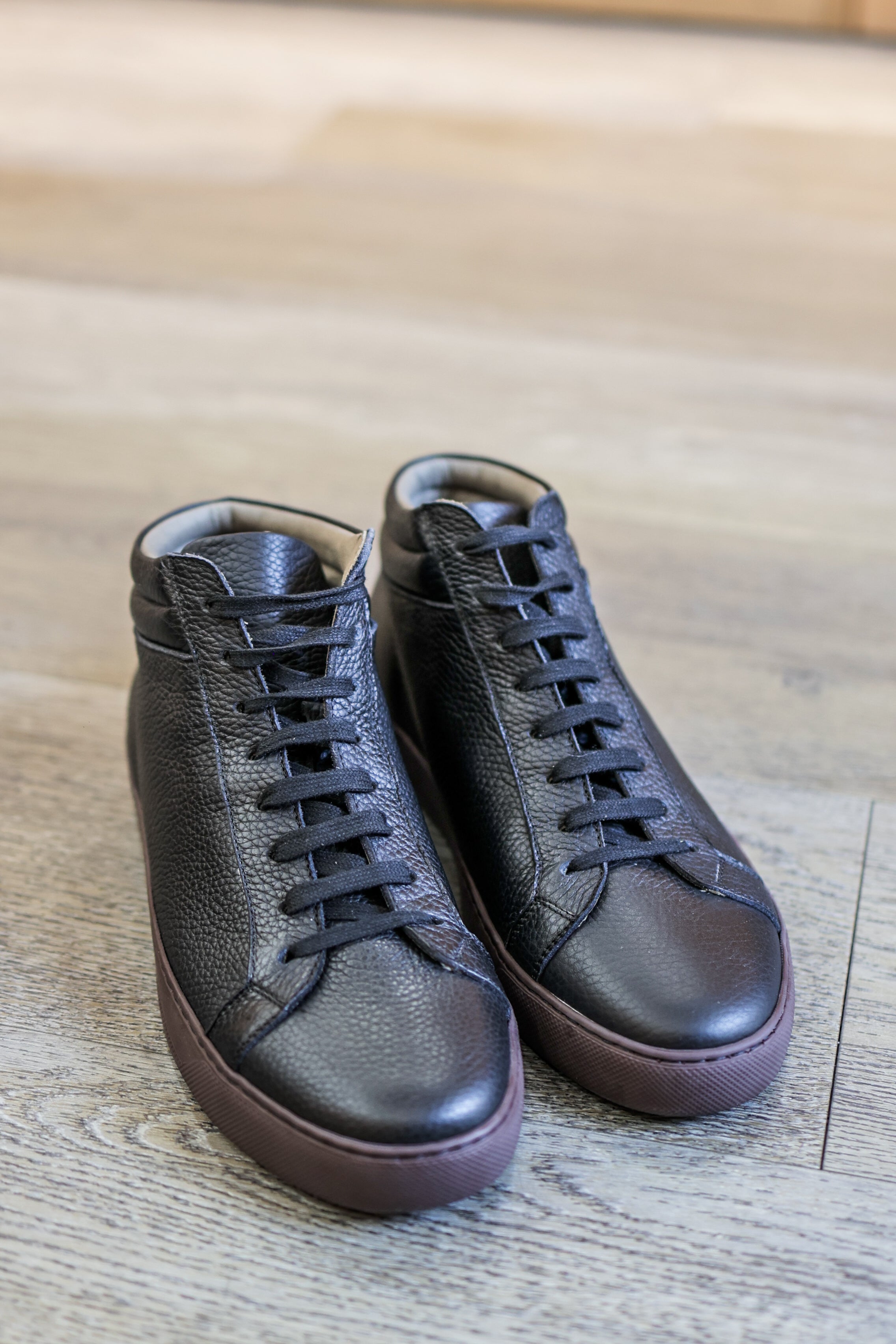 Black high top sneakers in textured leather